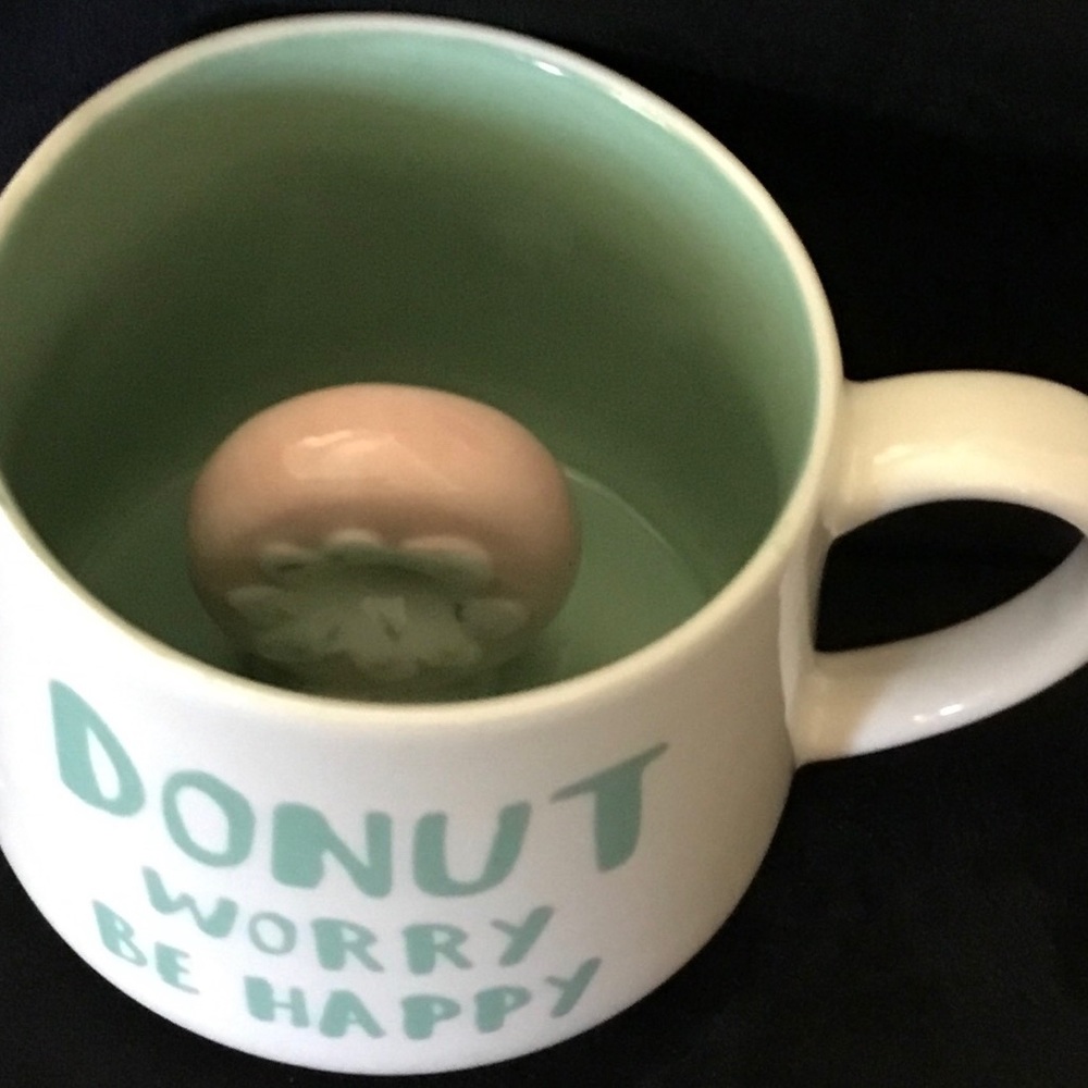 Coffee mug with donut inside. Don’t worry be happy on mug